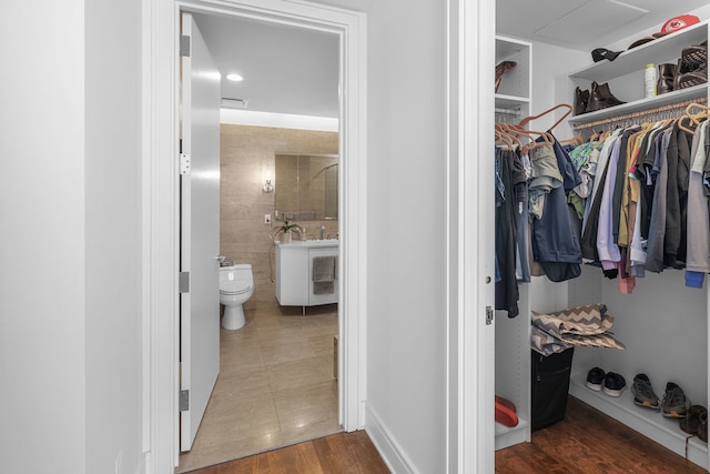 spacious closet featuring dark hardwood / wood-style floors