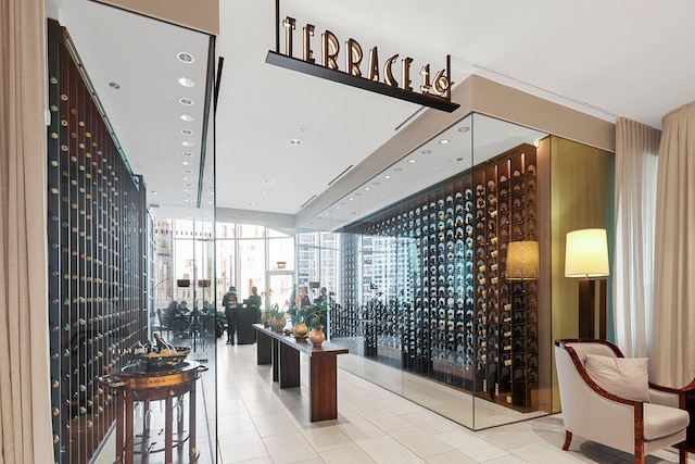 wine area with tile patterned floors and floor to ceiling windows