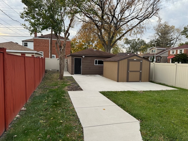 view of yard with a storage unit and a patio