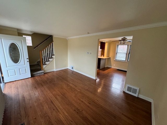 unfurnished living room featuring dark wood-type flooring, ceiling fan, and ornamental molding