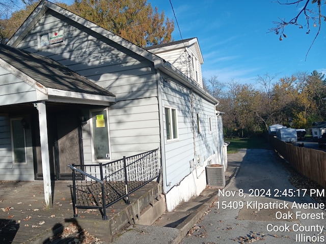 view of property exterior with central AC and a porch