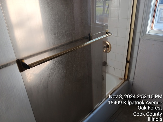 interior space featuring combined bath / shower with glass door