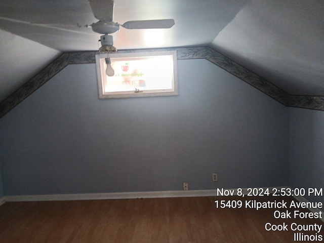 additional living space featuring hardwood / wood-style flooring, ceiling fan, and lofted ceiling