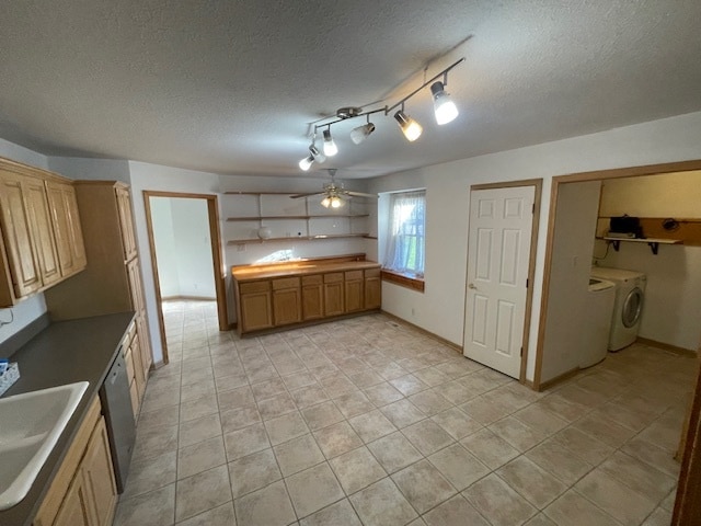 kitchen with separate washer and dryer, sink, stainless steel dishwasher, and a textured ceiling