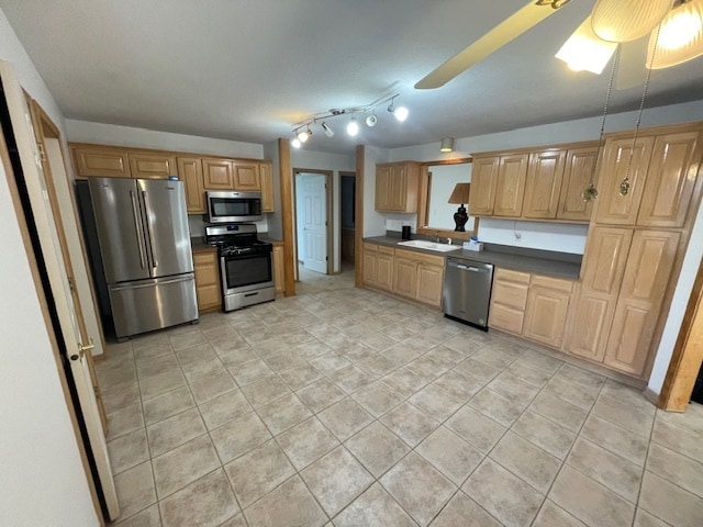 kitchen featuring ceiling fan, sink, light tile patterned floors, and stainless steel appliances