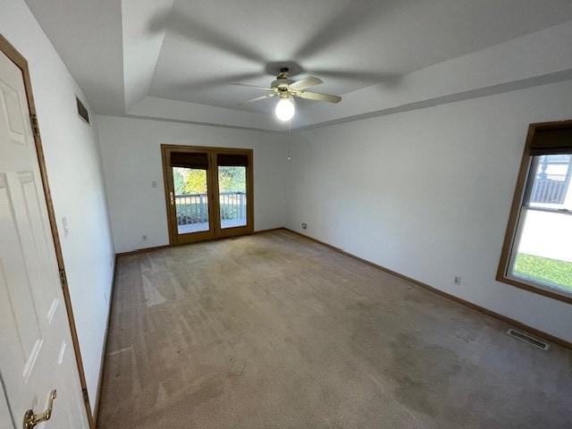 carpeted empty room featuring ceiling fan and french doors