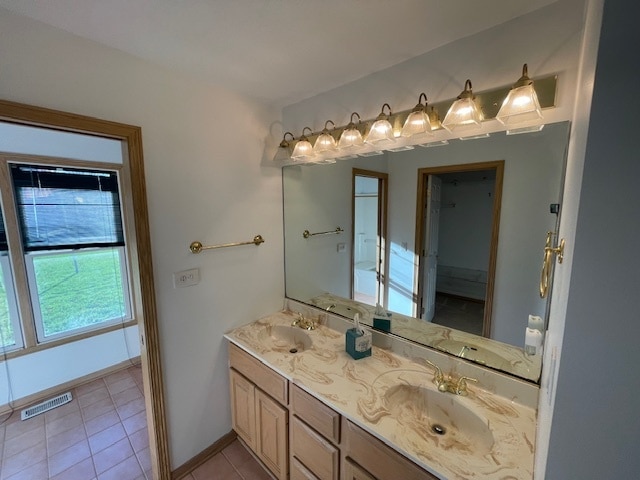 bathroom with tile patterned flooring and vanity