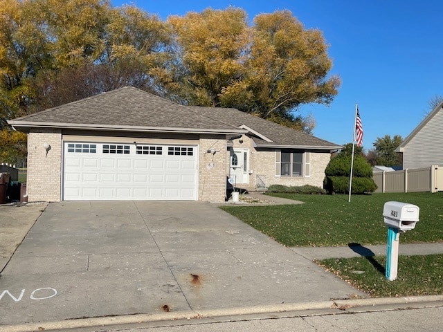 single story home with a front yard and a garage