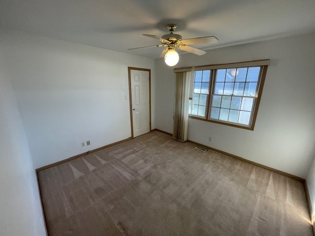 unfurnished room with ceiling fan and carpet floors