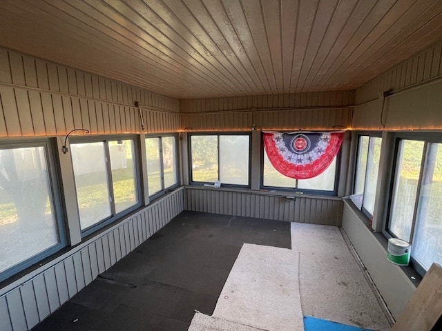 unfurnished sunroom featuring wooden ceiling and a healthy amount of sunlight