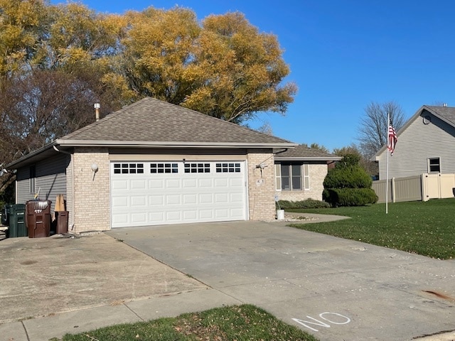 ranch-style home with a front yard and a garage