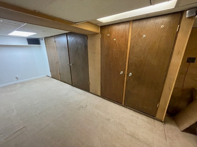 basement featuring light colored carpet