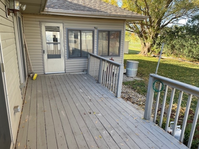 wooden terrace featuring a yard