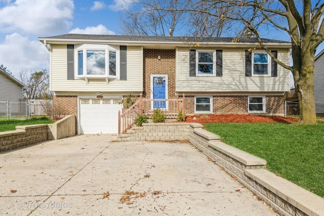 980 Brush Hill Ln, Lake Zurich, IL 60047 - raised ranch with brick siding, an attached garage, and driveway