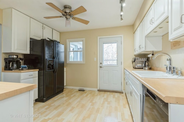980 Brush Hill Ln, Lake Zurich, IL 60047 - kitchen with butcher block countertops, a sink, black fridge, and white cabinetry