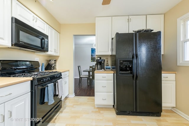 980 Brush Hill Ln, Lake Zurich, IL 60047 - kitchen featuring black appliances, light wood-type flooring, and white cabinets