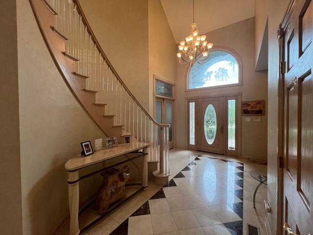 foyer entrance featuring a towering ceiling and a chandelier