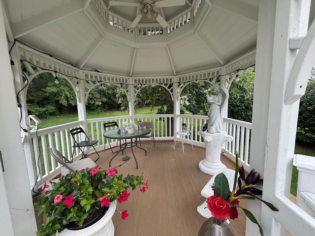 wooden deck with ceiling fan and a gazebo