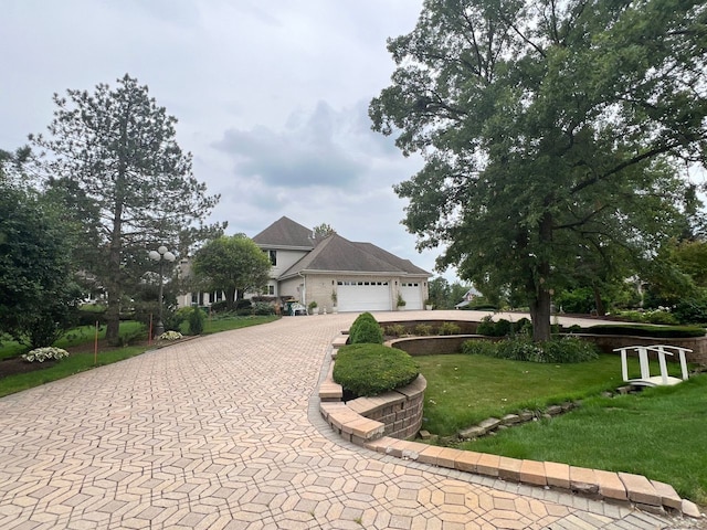 view of front of property featuring a garage and a front yard