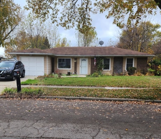 ranch-style home with a front lawn and a garage