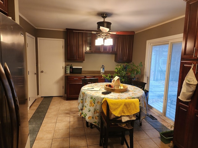 dining room featuring ceiling fan, light tile patterned floors, and ornamental molding