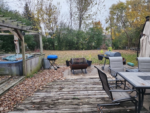 wooden terrace featuring a pergola and an outdoor fire pit