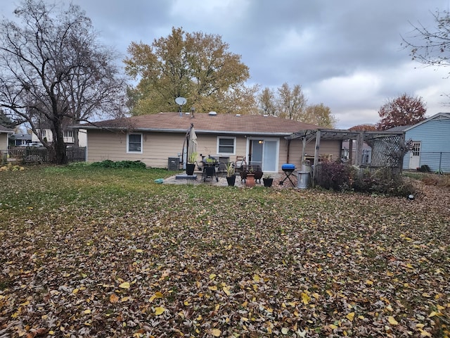 rear view of house featuring a lawn and a patio area