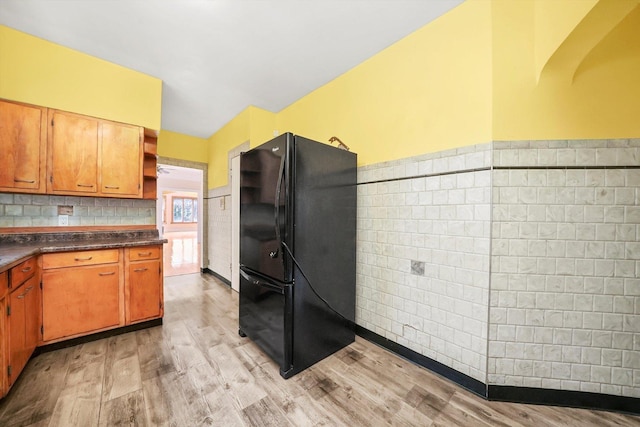 kitchen featuring black fridge and light wood-type flooring