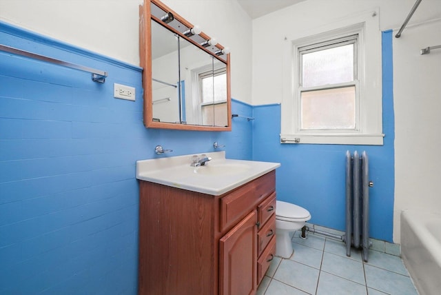 bathroom with tile patterned flooring, vanity, a bath, and toilet