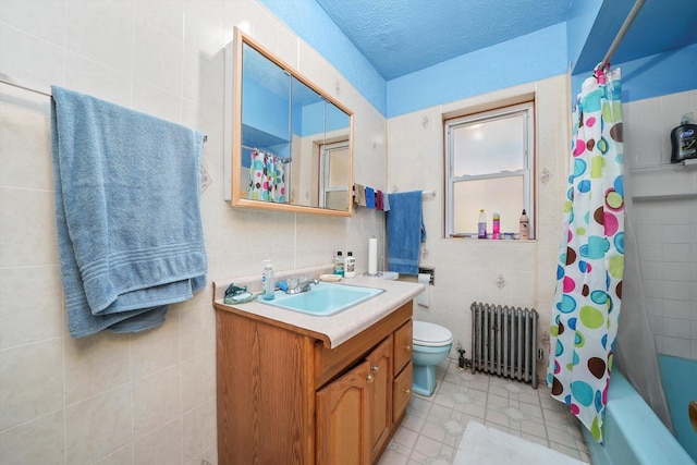 full bathroom with vanity, radiator, shower / bath combination with curtain, a textured ceiling, and tile walls