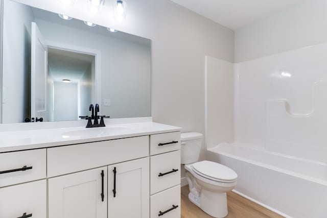 full bathroom featuring toilet, shower / tub combination, vanity, and wood-type flooring