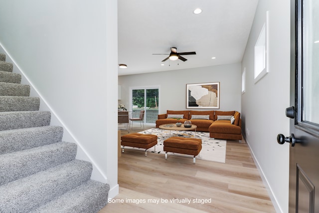 living room with light wood-type flooring and ceiling fan