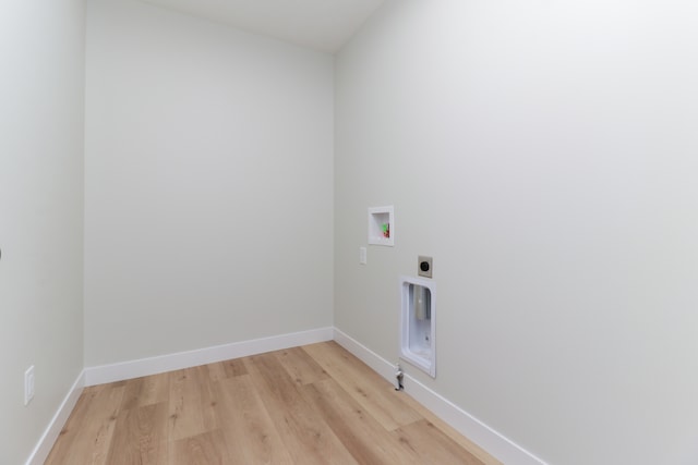 clothes washing area with washer hookup, light hardwood / wood-style flooring, and electric dryer hookup