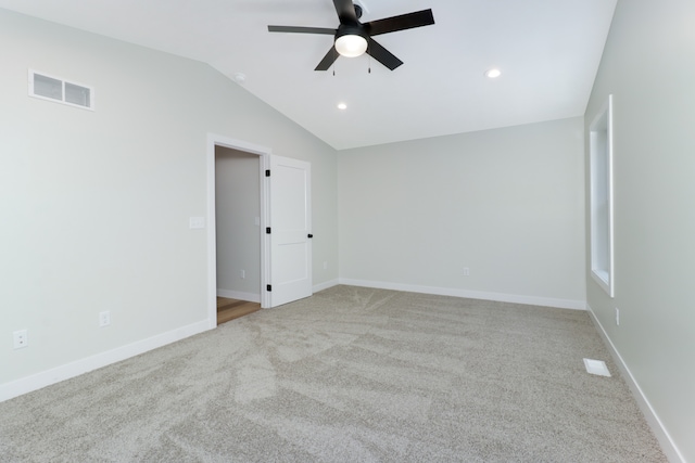 unfurnished room featuring ceiling fan, light colored carpet, and lofted ceiling