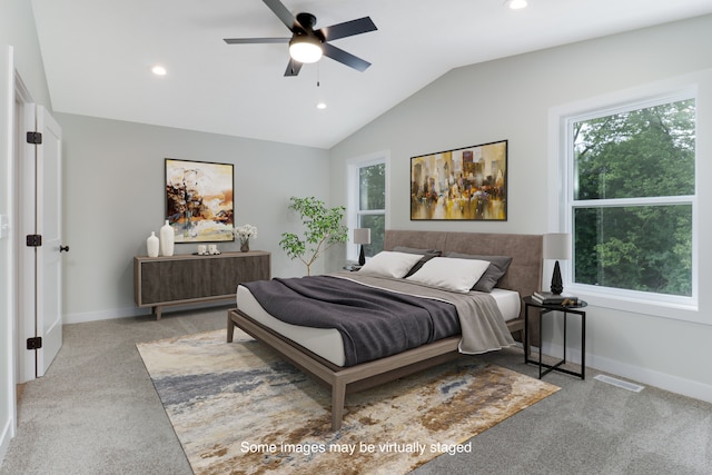 bedroom featuring vaulted ceiling, light colored carpet, and ceiling fan