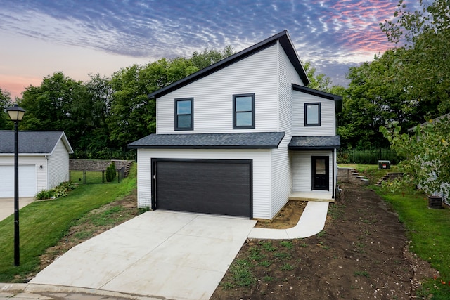 view of front facade with a lawn and a garage