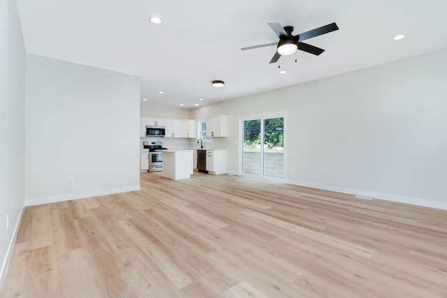 unfurnished living room with light hardwood / wood-style flooring and ceiling fan