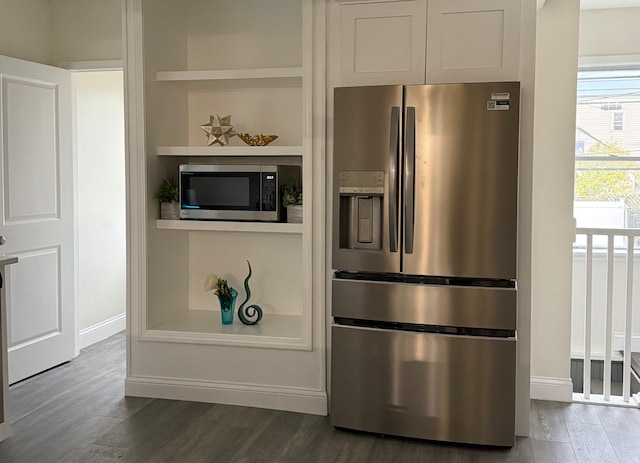 kitchen featuring white cabinetry, stainless steel appliances, and dark wood-type flooring