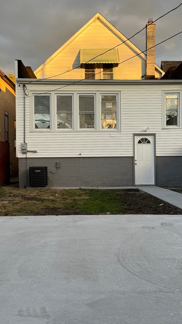 view of side of property featuring central AC