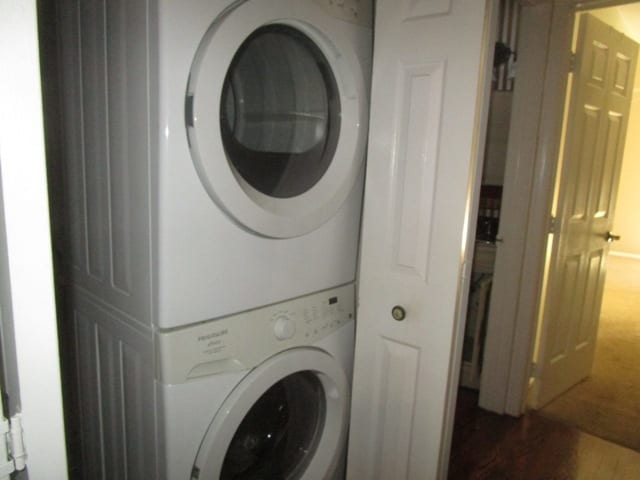 laundry area with stacked washer and clothes dryer