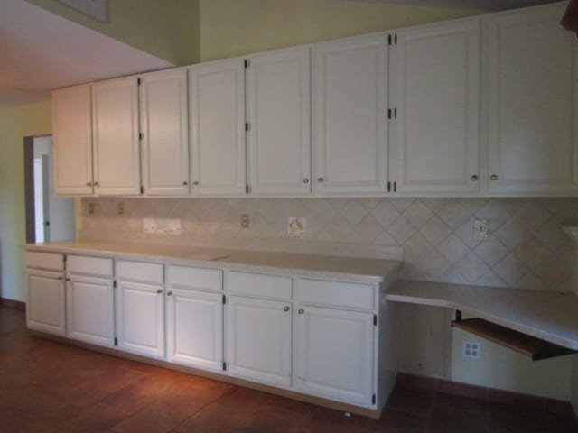 kitchen featuring white cabinets, dark hardwood / wood-style floors, and tasteful backsplash