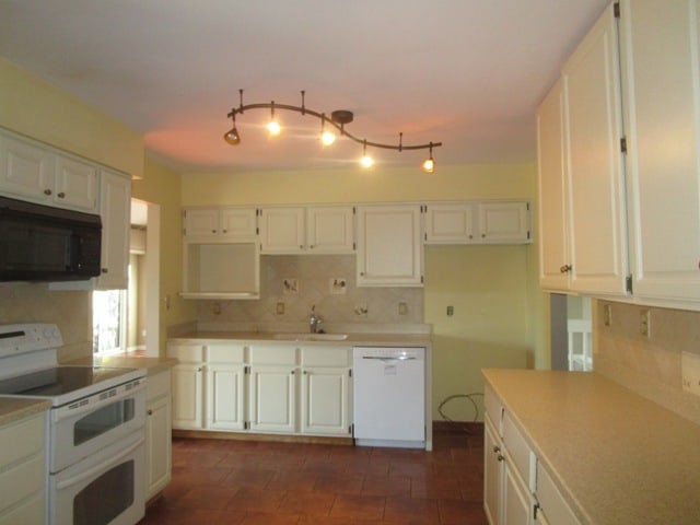 kitchen with white cabinetry, decorative backsplash, sink, and white appliances