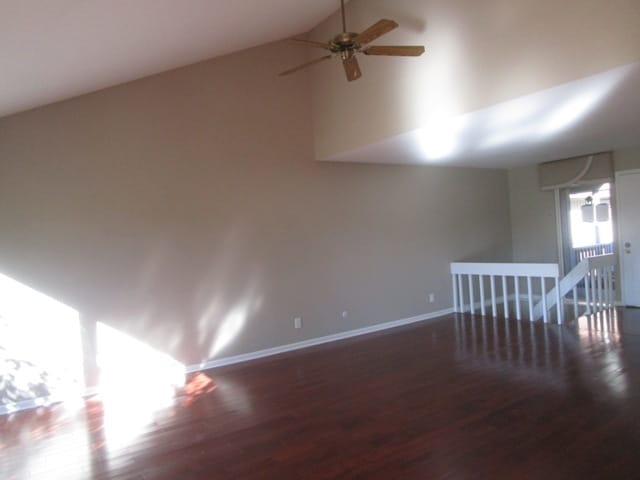 spare room featuring lofted ceiling, ceiling fan, and dark hardwood / wood-style flooring