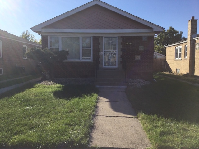 bungalow-style home with a front yard