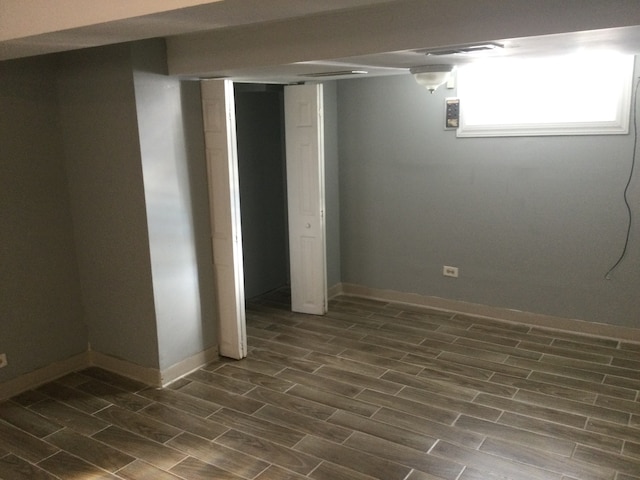 basement featuring dark hardwood / wood-style flooring