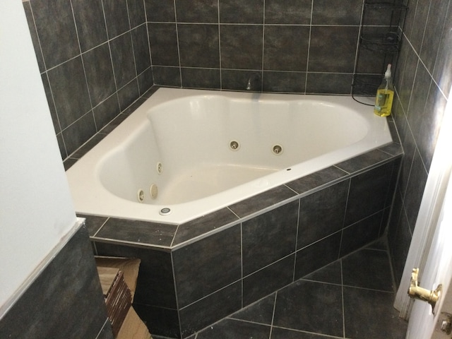 bathroom featuring tiled bath and tile patterned floors