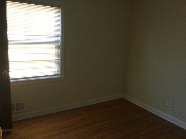 spare room with dark hardwood / wood-style flooring