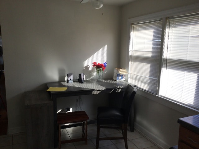 tiled dining room featuring a wealth of natural light and ceiling fan