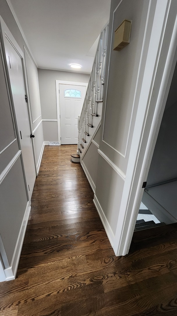 entryway with dark wood-type flooring