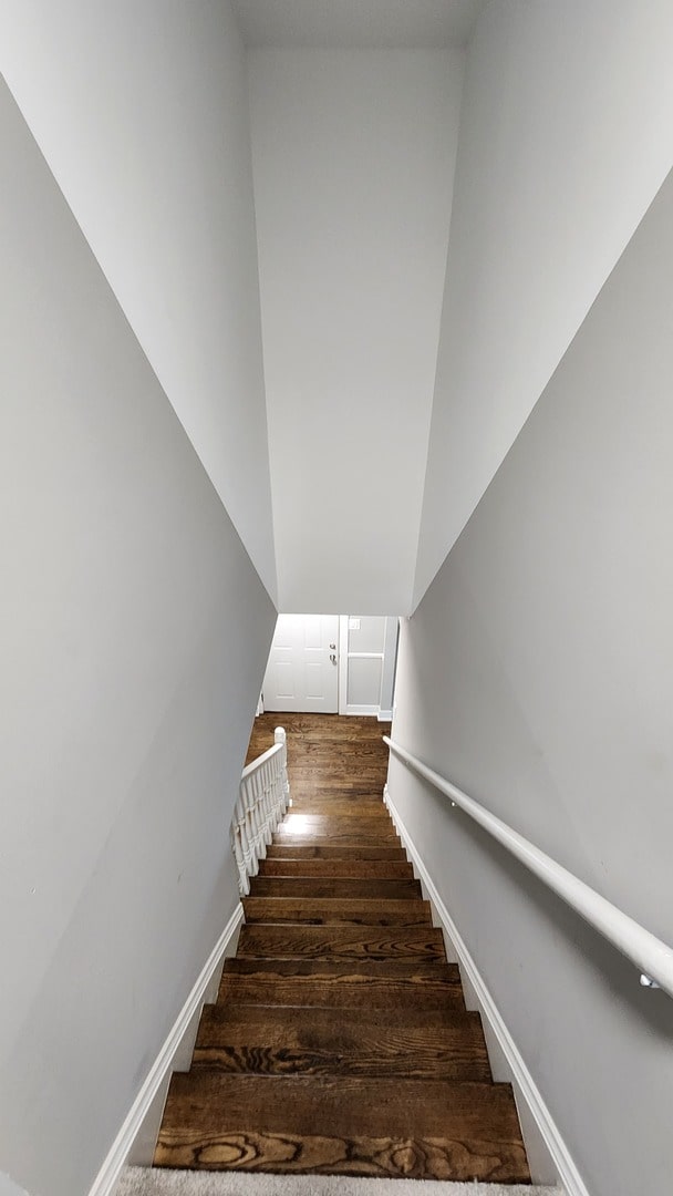 stairs featuring hardwood / wood-style floors